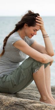 Upset crying woman by the ocean